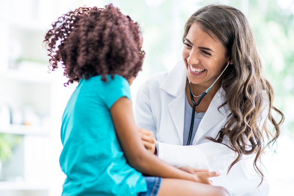Physician with little girl