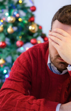 Sad man feeling negative emotions and alone during christmas